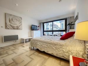 a bedroom with a bed and a large window at Gray d Albion THI235 in Cannes