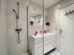 a white bathroom with a shower and a sink at Gray d Albion THI235 in Cannes