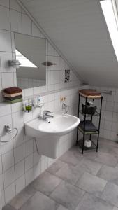 a white bathroom with a sink and a mirror at Stadt-Land-Fluss in Wickede (Ruhr)