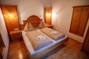 a bedroom with a bed with two towels on it at Haus Diana in Wagrain +39 photos