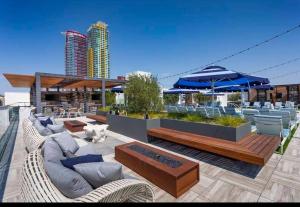 a patio with couches and umbrellas on a building at Lux Apt with Rooftop pool by Petco Park and Convention center 41 in San Diego