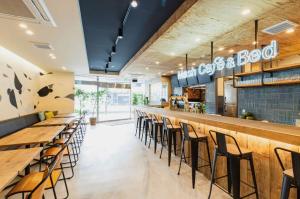 a bar in a restaurant with wooden tables and chairs at Mash Cafe & Bed NAGANO in Nagano +28 photos
