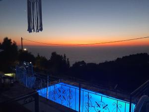 a view of the sunset from the balcony of a house at Sun And Stone in Athani