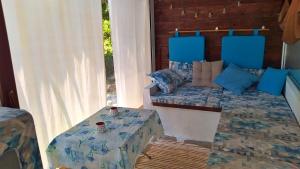 a room with a bed and a table in it at Casa Mary di Mare in Epanomi