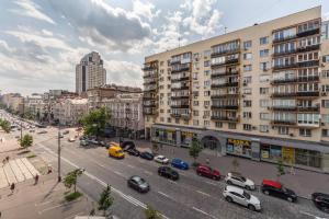 a city street with cars parked in front of buildings at Apartments on Velyka Vasylkivska 47 in Kyiv