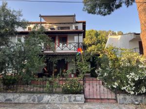 a house with a fence in front of it at Chic Villa with Terrace and Rooftop in Izmir in İzmir