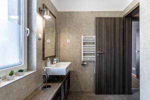 a bathroom with a sink and a mirror at Lake Side Luxury Steps To The Lake Lela - Happy Rentals in Balatonlelle