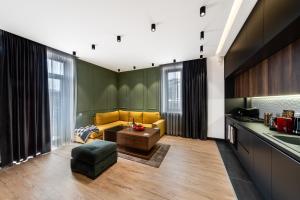 a living room with a yellow couch and a table at hotelise I Palermo Apartment in Yerevan