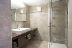 a bathroom with a sink and a shower at Mountain View Apartment in Zermatt - Denali in Zermatt