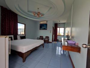 a bedroom with a bed and a table and chairs at ERAWAN PLACE in Mae Sot