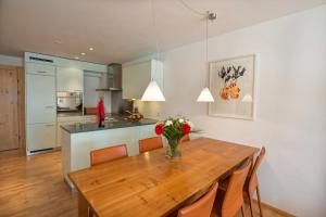 a kitchen and dining room with a wooden table and chairs at Neiva in Arosa