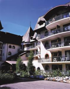 a large building with balconies on the side of it at Lagrange Vacances Le Cristal d'Argentière in Chamonix-Mont-Blanc