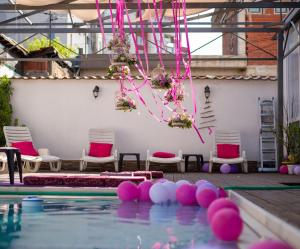 a pool with pink and white balls in the water at Family Hotel Ring & Thermal in Kyustendil