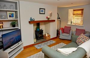 a living room with a couch and a television at 'Maigue View' by the River in Croom