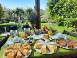 a table topped with plates of bread and pastries at Agriturismo le colline di Capalbio in Capalbio +27 photos