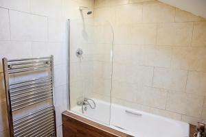 a bathroom with a shower with a bath tub at 'Maigue View' by the River in Croom +28 photos