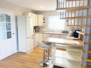 a kitchen with white appliances and a white refrigerator at Castlehill in Dundee