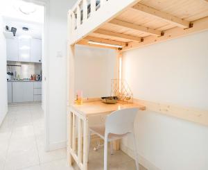 a kitchen and dining room with a table and a staircase at Shared dormitory Wan Chai Road 187 in Hong Kong