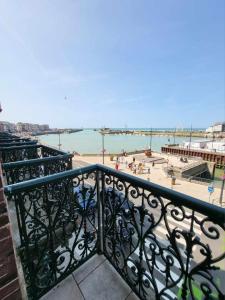 a balcony with a view of a beach and the ocean at Les 5 balcons in Le Tréport