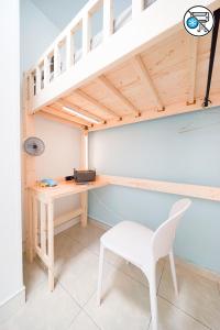 a desk and a white chair in a room at Shared dormitory Wan Chai Road 187 in Hong Kong