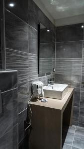 a bathroom with a sink and a mirror at MIRA LUXURY APARTMENTS in Paralia Dionysiou
