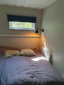 a bed in a bedroom with a window at Stugan in Stockholm