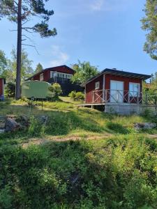 a house on a grassy hill with a house at Stugan in Stockholm