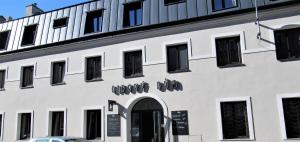 a white building with the words monk dog on it at Lidový dům Opava in Opava