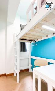 a bunk bed in a room with a table and a desk at Shared Apartment Lockhart Road 384 in Hong Kong