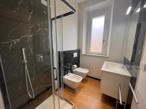 a bathroom with a toilet and a sink and a shower at Happy Holiday Apartment in Cagliari