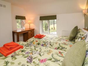a bedroom with two beds and a window at Min Y Nant in Welshpool