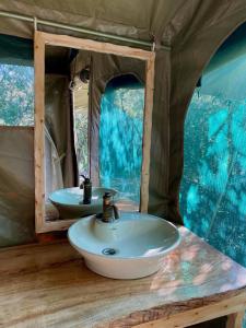 a bathroom with a sink in a tent at Echoes of Eden: River Retreat in Naivasha