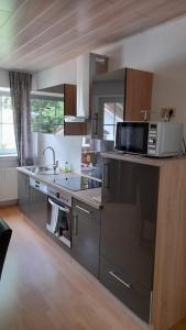 a kitchen with a microwave and a stove top oven at Stadt-Land-Fluss in Wickede (Ruhr)