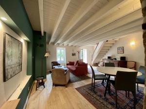 a living room with a table and a couch at Le Presbytère in Tréffiagat