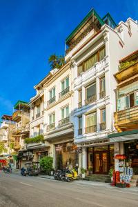 a tall white building on a city street at Hanoi La Palm Premier Hotel & Spa in Hanoi