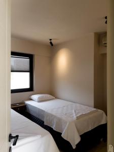 a hotel room with two beds and a window at Koy Villa in Mugla