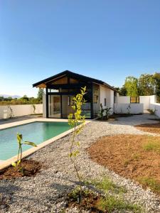 a home with a swimming pool and a house at Koy Villa in Muğla