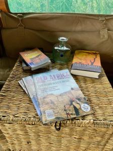 a basket with books and a candle on a table at Echoes of Eden: Forest Haven in Melewa