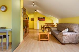 a living room with a couch and a table at Atico la Espata Villanua in Villanúa +4 photos