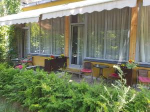 a porch of a house with chairs and a table at Nėris Inn Terraces in Vilnius