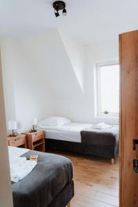 a bedroom with two beds and a window at Noclegi Przy Stacji in Nowy Dwór Mazowiecki