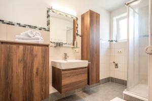 a bathroom with a sink and a shower at Alpha Apartments in Schwarzach im Pongau