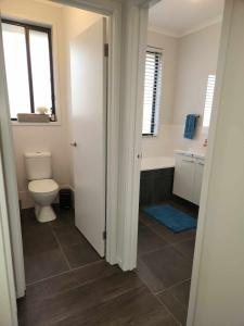 a bathroom with a toilet and a sink and a window at RIVER VIEWS in Hindmarsh Island