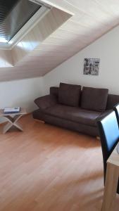 a living room with a black couch and a table at Stadt-Land-Fluss in Wickede (Ruhr)