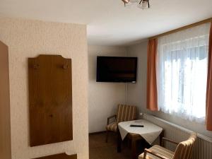 a hotel room with a small table and a television at Gasthaus Waldhorn in Bad Teinach-Zavelstein