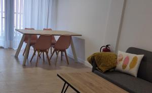 a living room with a table and chairs and a couch at Txoko Loft Ribera in Tudela +5 photos