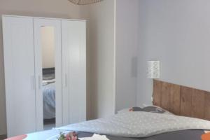 a bedroom with a bed and a mirror at Maison au calme avec jardin et parking privé in Rouairoux