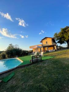 a house with a swimming pool in front of it at La massaria di Cesare in Pianella