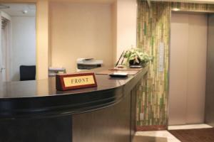 an office desk with a sign that reads front at Shinjuku Sun Park Hotel in Tokyo