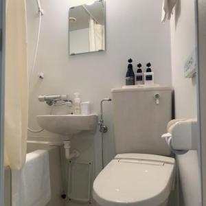 a bathroom with a white toilet and a sink at Shinjuku Sun Park Hotel in Tokyo